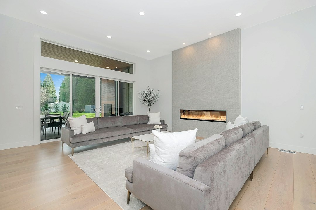 Modern living room with grey sofas and a fireplace.